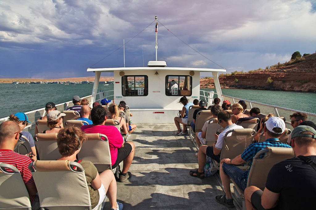 Passengers seated on a crowded charter boat during a trip