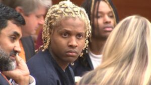 Lil Durk sits in court beside his legal team