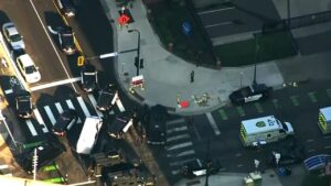 Police and emergency vehicles crowd an intersection near a Minneapolis high-rise after gunfire