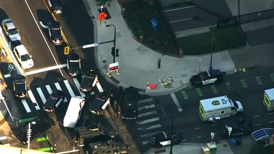 Police and emergency vehicles crowd an intersection near a Minneapolis high-rise after gunfire