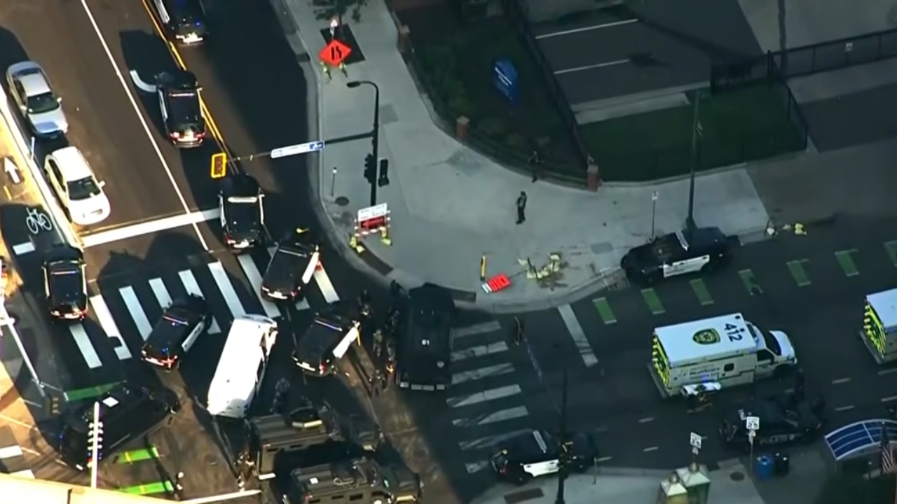 Police and emergency vehicles crowd an intersection near a Minneapolis high-rise after gunfire