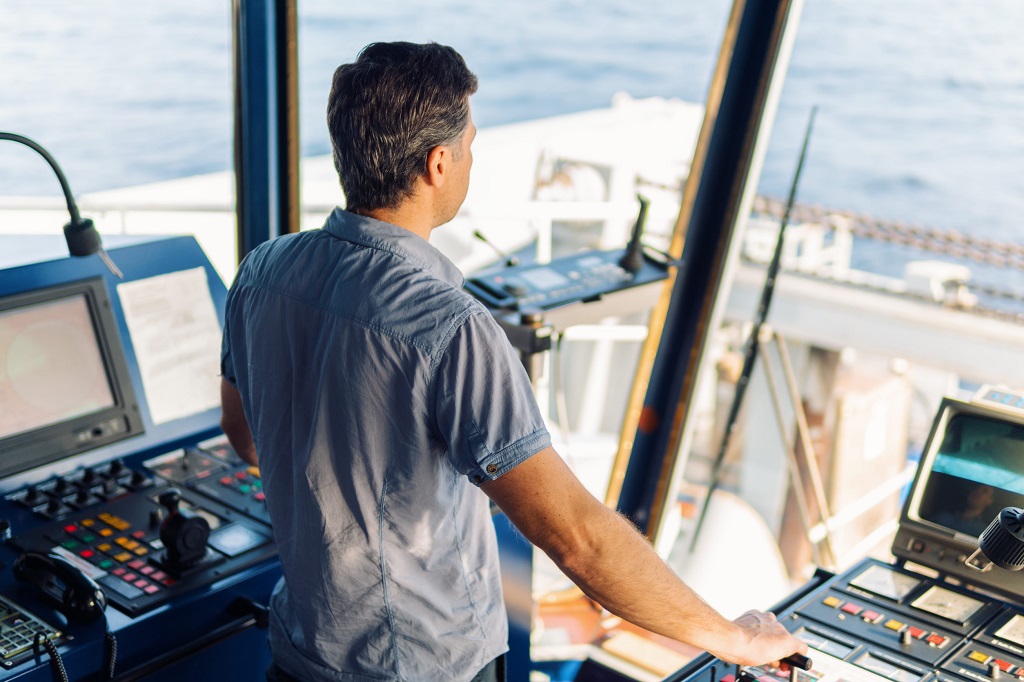 Boat captain operating controls from the wheelhouse