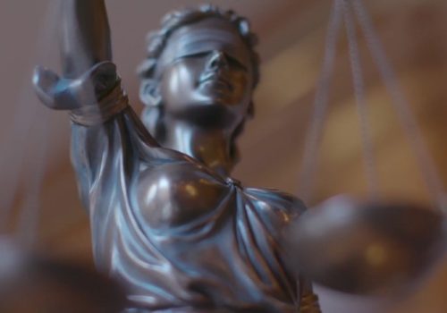 A statue of Justice holding a balanced scale