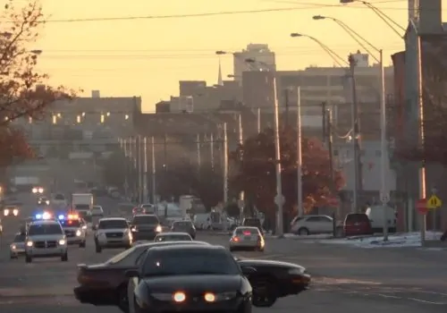 Police car in a busy traffic during sunset in North Philly