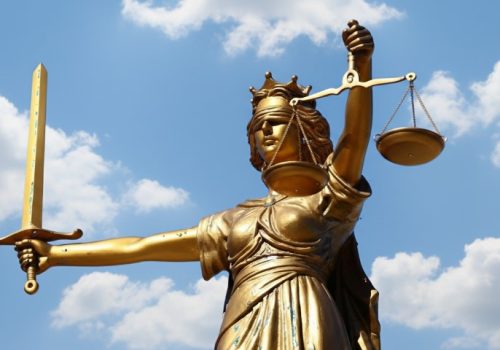 Statue of Lady Justice holding a sword in one hand and scales in the other